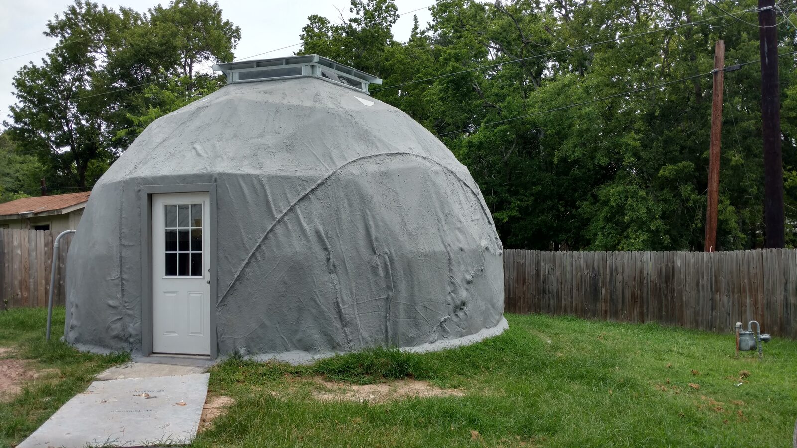 Finished dome with white door, walkway, and cupola