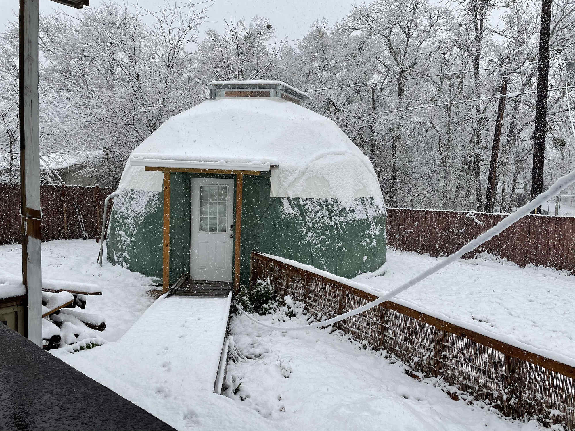 The proof dome under heavy snow, green shell and cupola visible